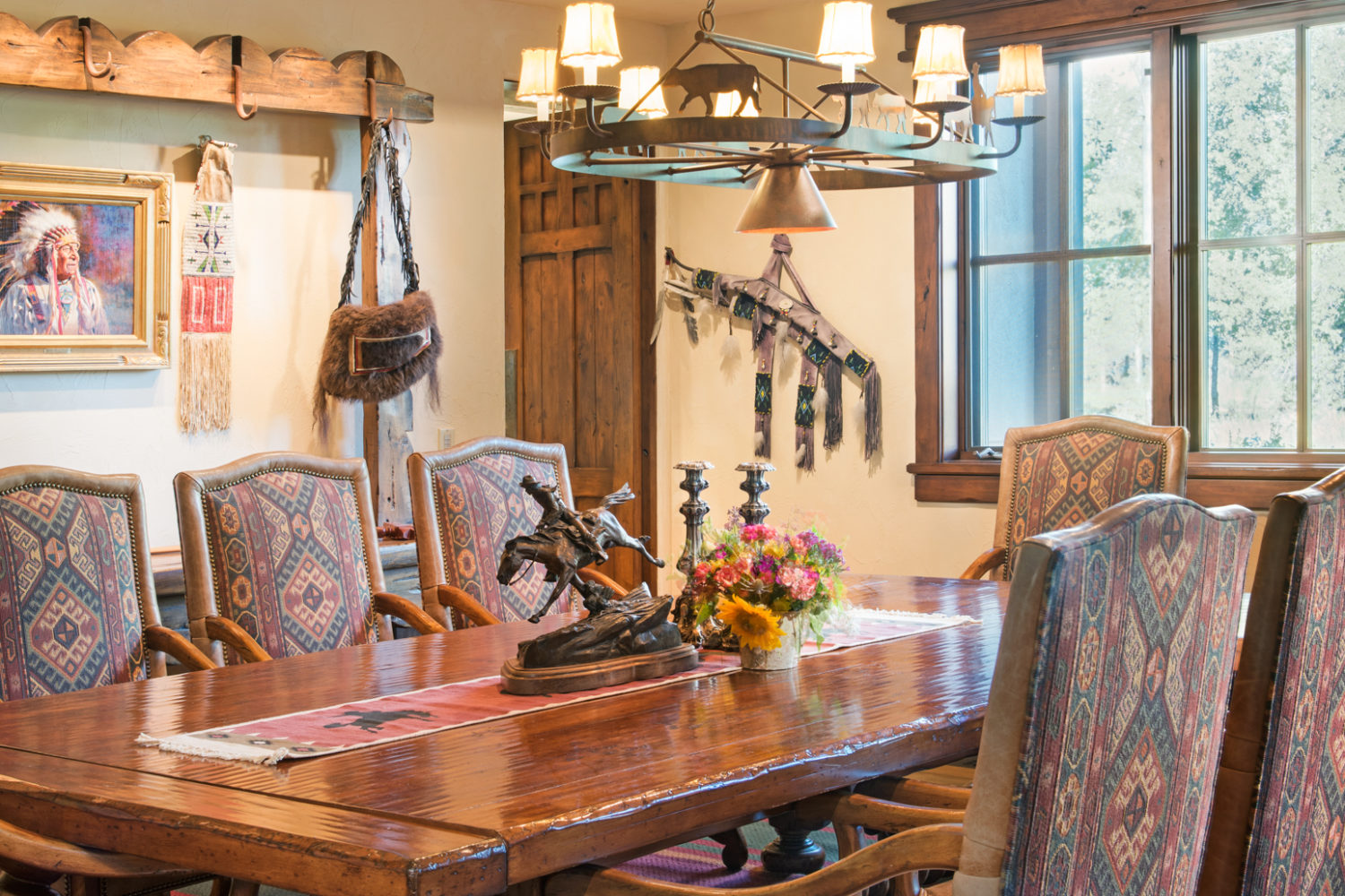 A formal spacious dining room with western art and furniture