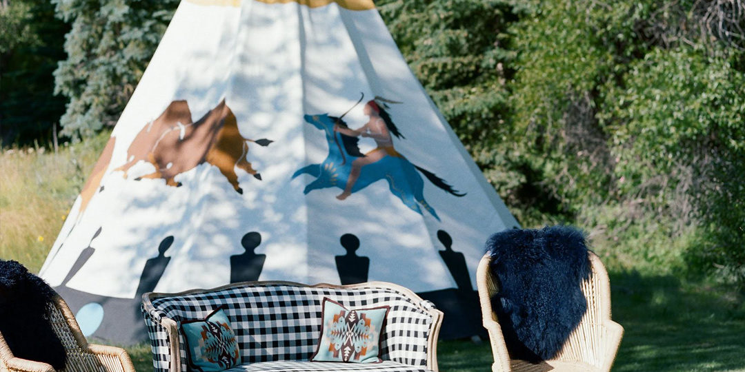 A cozy lounge set up in front of a teepee